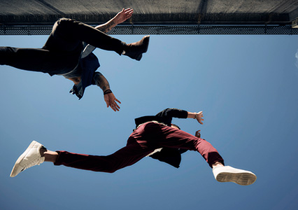 Image of two people jumping from below